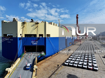 A roll-on wheel is loaded with cars for export at the terminal of Orient Port Branch in Lianyungang Port in Lianyungang, China, on November...