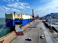 A roll-on wheel is loaded with cars for export at the terminal of Orient Port Branch in Lianyungang Port in Lianyungang, China, on November...