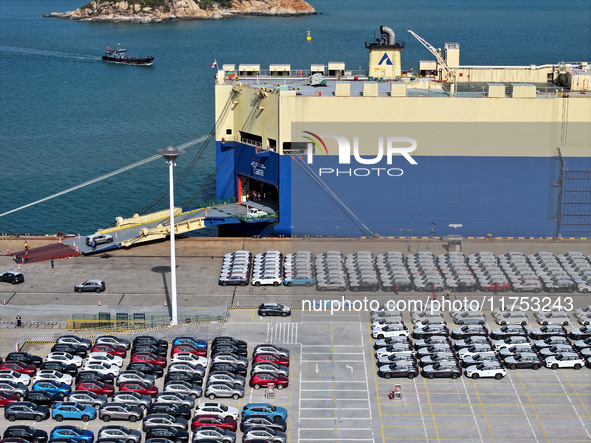 A roll-on wheel is loaded with cars for export at the terminal of Orient Port Branch in Lianyungang Port in Lianyungang, China, on November...