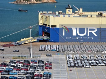 A roll-on wheel is loaded with cars for export at the terminal of Orient Port Branch in Lianyungang Port in Lianyungang, China, on November...