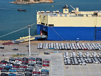 A roll-on wheel is loaded with cars for export at the terminal of Orient Port Branch in Lianyungang Port in Lianyungang, China, on November...