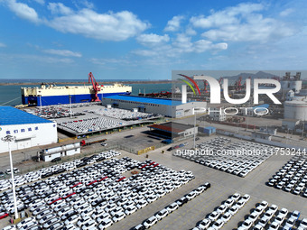 A roll-on wheel is loaded with cars for export at the terminal of Orient Port Branch in Lianyungang Port in Lianyungang, China, on November...