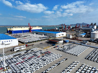 A roll-on wheel is loaded with cars for export at the terminal of Orient Port Branch in Lianyungang Port in Lianyungang, China, on November...