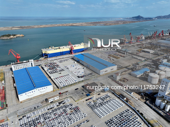 A roll-on wheel is loaded with cars for export at the terminal of Orient Port Branch in Lianyungang Port in Lianyungang, China, on November...