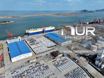 A roll-on wheel is loaded with cars for export at the terminal of Orient Port Branch in Lianyungang Port in Lianyungang, China, on November...