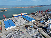 A roll-on wheel is loaded with cars for export at the terminal of Orient Port Branch in Lianyungang Port in Lianyungang, China, on November...