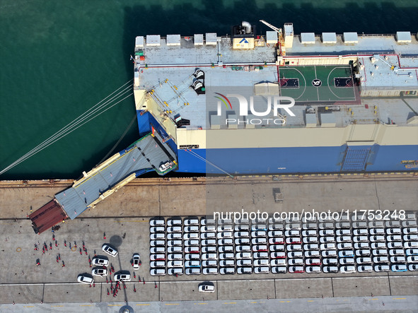 A roll-on wheel is loaded with cars for export at the terminal of Orient Port Branch in Lianyungang Port in Lianyungang, China, on November...