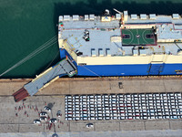 A roll-on wheel is loaded with cars for export at the terminal of Orient Port Branch in Lianyungang Port in Lianyungang, China, on November...