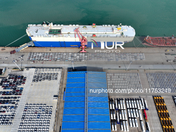 A roll-on wheel is loaded with cars for export at the terminal of Orient Port Branch in Lianyungang Port in Lianyungang, China, on November...