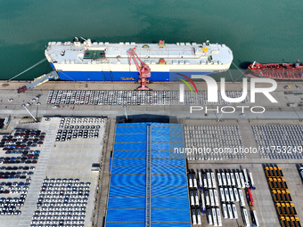 A roll-on wheel is loaded with cars for export at the terminal of Orient Port Branch in Lianyungang Port in Lianyungang, China, on November...