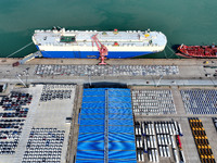 A roll-on wheel is loaded with cars for export at the terminal of Orient Port Branch in Lianyungang Port in Lianyungang, China, on November...