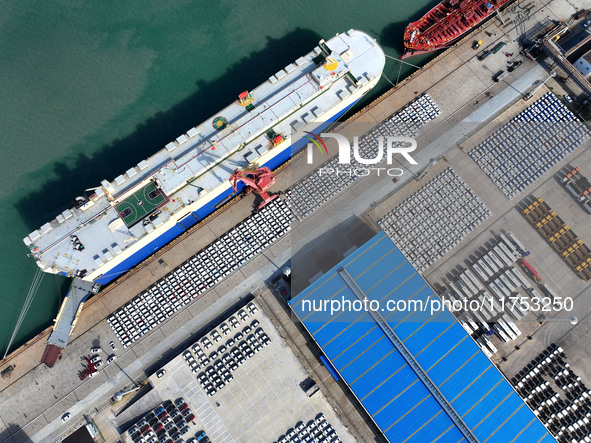 A roll-on wheel is loaded with cars for export at the terminal of Orient Port Branch in Lianyungang Port in Lianyungang, China, on November...