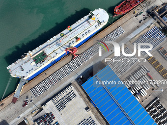 A roll-on wheel is loaded with cars for export at the terminal of Orient Port Branch in Lianyungang Port in Lianyungang, China, on November...