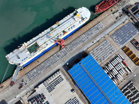 A roll-on wheel is loaded with cars for export at the terminal of Orient Port Branch in Lianyungang Port in Lianyungang, China, on November...