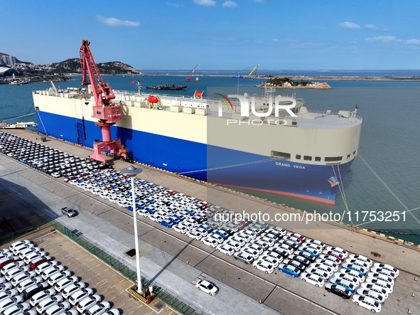 A roll-on wheel is loaded with cars for export at the terminal of Orient Port Branch in Lianyungang Port in Lianyungang, China, on November...