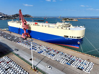 A roll-on wheel is loaded with cars for export at the terminal of Orient Port Branch in Lianyungang Port in Lianyungang, China, on November...