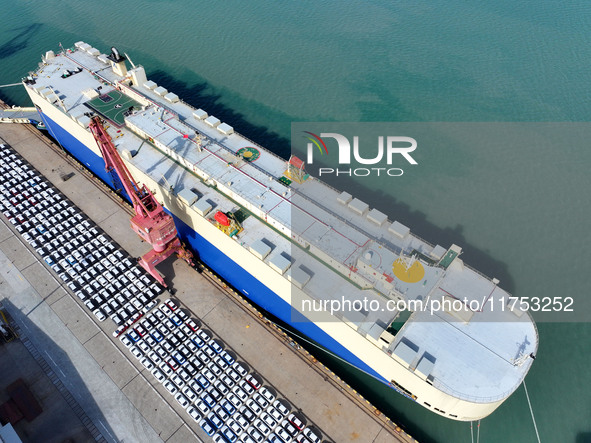 A roll-on wheel is loaded with cars for export at the terminal of Orient Port Branch in Lianyungang Port in Lianyungang, China, on November...