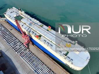 A roll-on wheel is loaded with cars for export at the terminal of Orient Port Branch in Lianyungang Port in Lianyungang, China, on November...