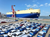 A roll-on wheel is loaded with cars for export at the terminal of Orient Port Branch in Lianyungang Port in Lianyungang, China, on November...