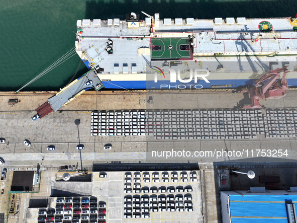 A roll-on wheel is loaded with cars for export at the terminal of Orient Port Branch in Lianyungang Port in Lianyungang, China, on November...