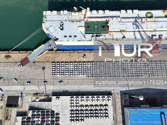 A roll-on wheel is loaded with cars for export at the terminal of Orient Port Branch in Lianyungang Port in Lianyungang, China, on November...