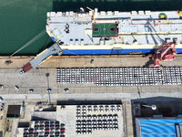 A roll-on wheel is loaded with cars for export at the terminal of Orient Port Branch in Lianyungang Port in Lianyungang, China, on November...