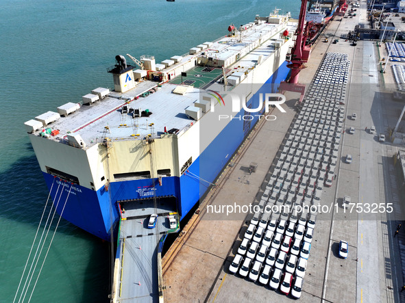 A roll-on wheel is loaded with cars for export at the terminal of Orient Port Branch in Lianyungang Port in Lianyungang, China, on November...