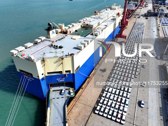 A roll-on wheel is loaded with cars for export at the terminal of Orient Port Branch in Lianyungang Port in Lianyungang, China, on November...