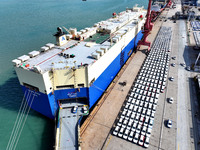 A roll-on wheel is loaded with cars for export at the terminal of Orient Port Branch in Lianyungang Port in Lianyungang, China, on November...