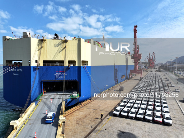 A roll-on wheel is loaded with cars for export at the terminal of Orient Port Branch in Lianyungang Port in Lianyungang, China, on November...