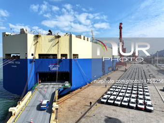 A roll-on wheel is loaded with cars for export at the terminal of Orient Port Branch in Lianyungang Port in Lianyungang, China, on November...