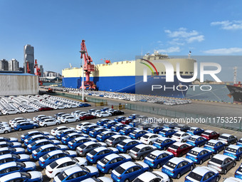 A roll-on wheel is loaded with cars for export at the terminal of Orient Port Branch in Lianyungang Port in Lianyungang, China, on November...