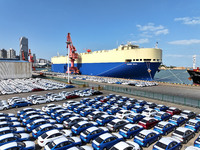 A roll-on wheel is loaded with cars for export at the terminal of Orient Port Branch in Lianyungang Port in Lianyungang, China, on November...