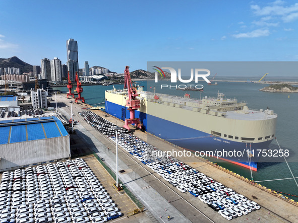 A roll-on wheel is loaded with cars for export at the terminal of Orient Port Branch in Lianyungang Port in Lianyungang, China, on November...