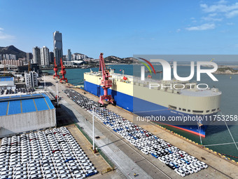 A roll-on wheel is loaded with cars for export at the terminal of Orient Port Branch in Lianyungang Port in Lianyungang, China, on November...