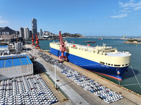 A roll-on wheel is loaded with cars for export at the terminal of Orient Port Branch in Lianyungang Port in Lianyungang, China, on November...