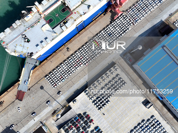 A roll-on wheel is loaded with cars for export at the terminal of Orient Port Branch in Lianyungang Port in Lianyungang, China, on November...