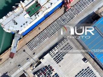 A roll-on wheel is loaded with cars for export at the terminal of Orient Port Branch in Lianyungang Port in Lianyungang, China, on November...