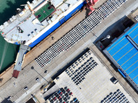 A roll-on wheel is loaded with cars for export at the terminal of Orient Port Branch in Lianyungang Port in Lianyungang, China, on November...