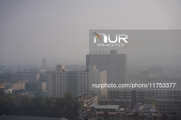 Buildings are faintly visible in the haze in Xi'an, China, on November 8, 2024. 