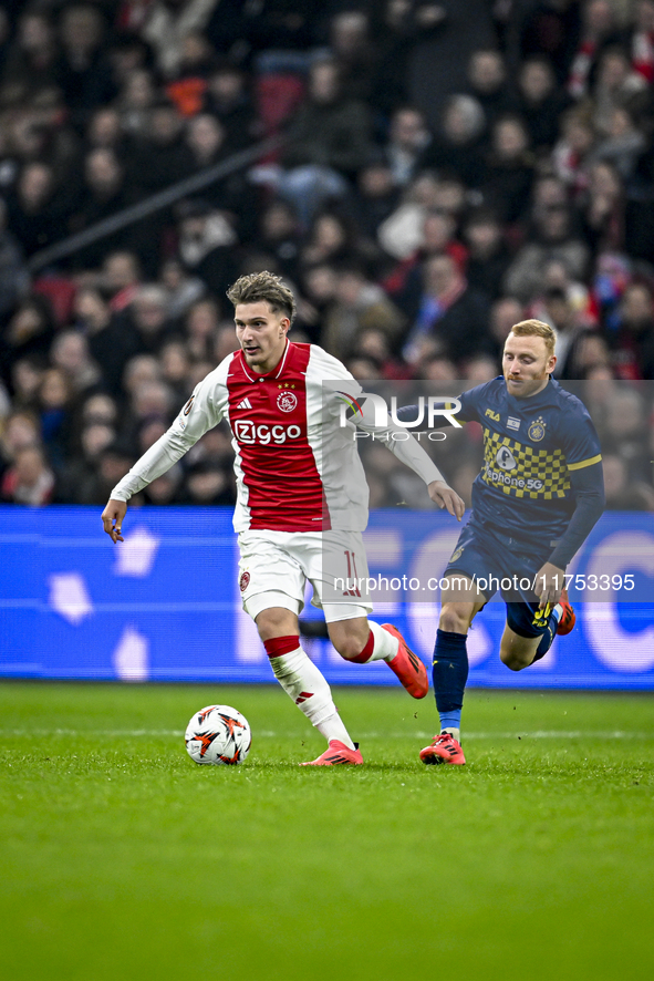 AFC Ajax Amsterdam forward Mika Godts and Maccabi Tel Aviv midfielder Ido Shahar play during the match between Ajax and Maccabi Tel Aviv at...