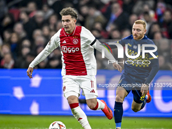 AFC Ajax Amsterdam forward Mika Godts and Maccabi Tel Aviv midfielder Ido Shahar play during the match between Ajax and Maccabi Tel Aviv at...