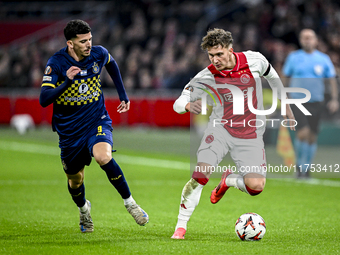 Maccabi Tel Aviv forward Dor Turgeman and AFC Ajax Amsterdam forward Mika Godts play during the match between Ajax and Maccabi Tel Aviv at t...