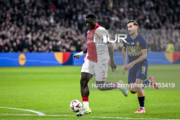 AFC Ajax Amsterdam forward Brian Brobbey and Maccabi Tel Aviv defender Nemanja Stojic play during the match between Ajax and Maccabi Tel Avi...