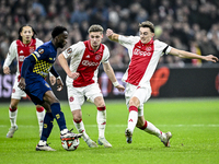 Maccabi Tel Aviv midfielder Issouf Sissokho, AFC Ajax Amsterdam midfielder Kenneth Taylor, and AFC Ajax Amsterdam defender Youri Baas partic...