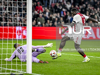 Maccabi Tel Aviv goalkeeper Roi Mishpati and AFC Ajax Amsterdam forward Brian Brobbey participate in the match between Ajax and Maccabi Tel...