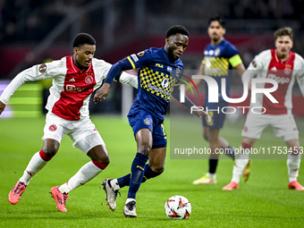 AFC Ajax Amsterdam defender Jorrel Hato and Maccabi Tel Aviv midfielder Issouf Sissokho play during the match between Ajax and Maccabi Tel A...