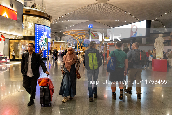 Passengers walk the allies of Istanbul Airport, in the capital of Turkiye on November 3, 2024. Istanbul Airport was named the second busiest...