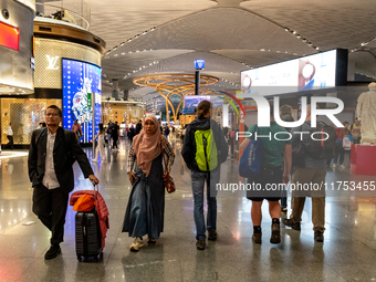 Passengers walk the allies of Istanbul Airport, in the capital of Turkiye on November 3, 2024. Istanbul Airport was named the second busiest...