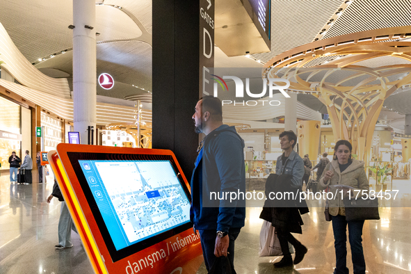 Passengers walk the allies of Istanbul Airport, in the capital of Turkiye on November 3, 2024. Istanbul Airport was named the second busiest...